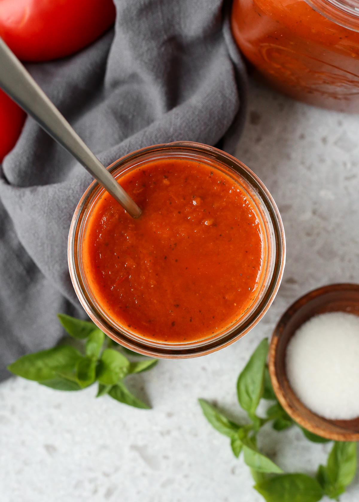 Overhead view of a glass mason jar filled with a slow cooker marinara sauce.