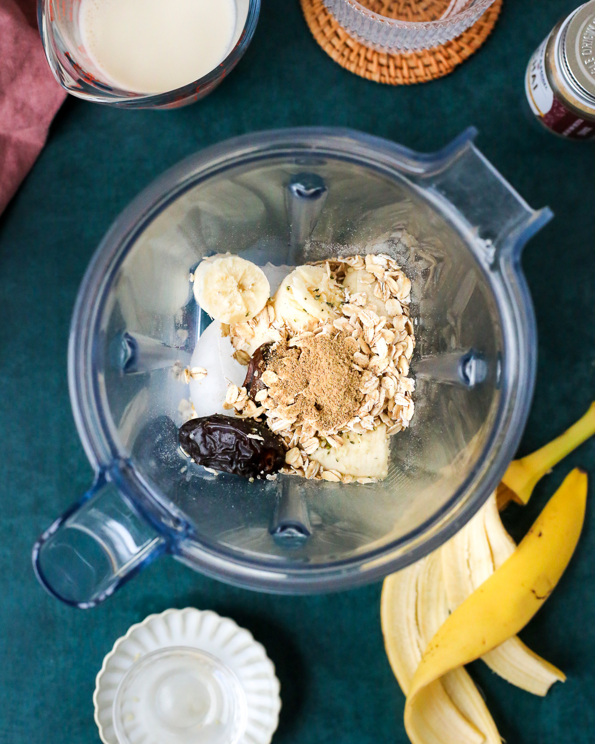 The dry ingredients of a banana chai smoothie, unmixed, in a blender on the countertop. 
