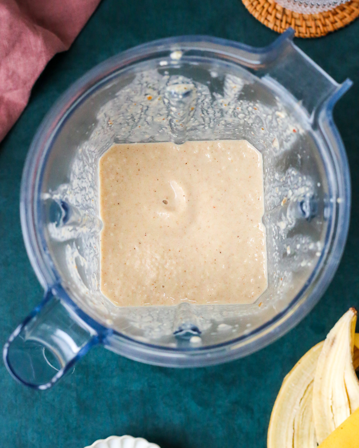 An overhead view into a blender that contains a banana chai smoothie. 