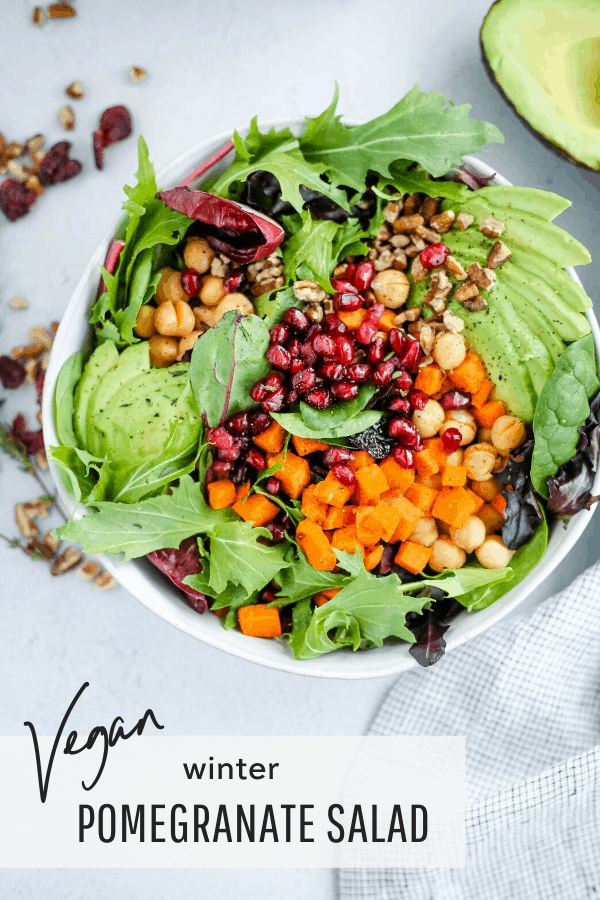 Colorful salad with fresh avocado, sweet potatoes, and pomegranate seeds