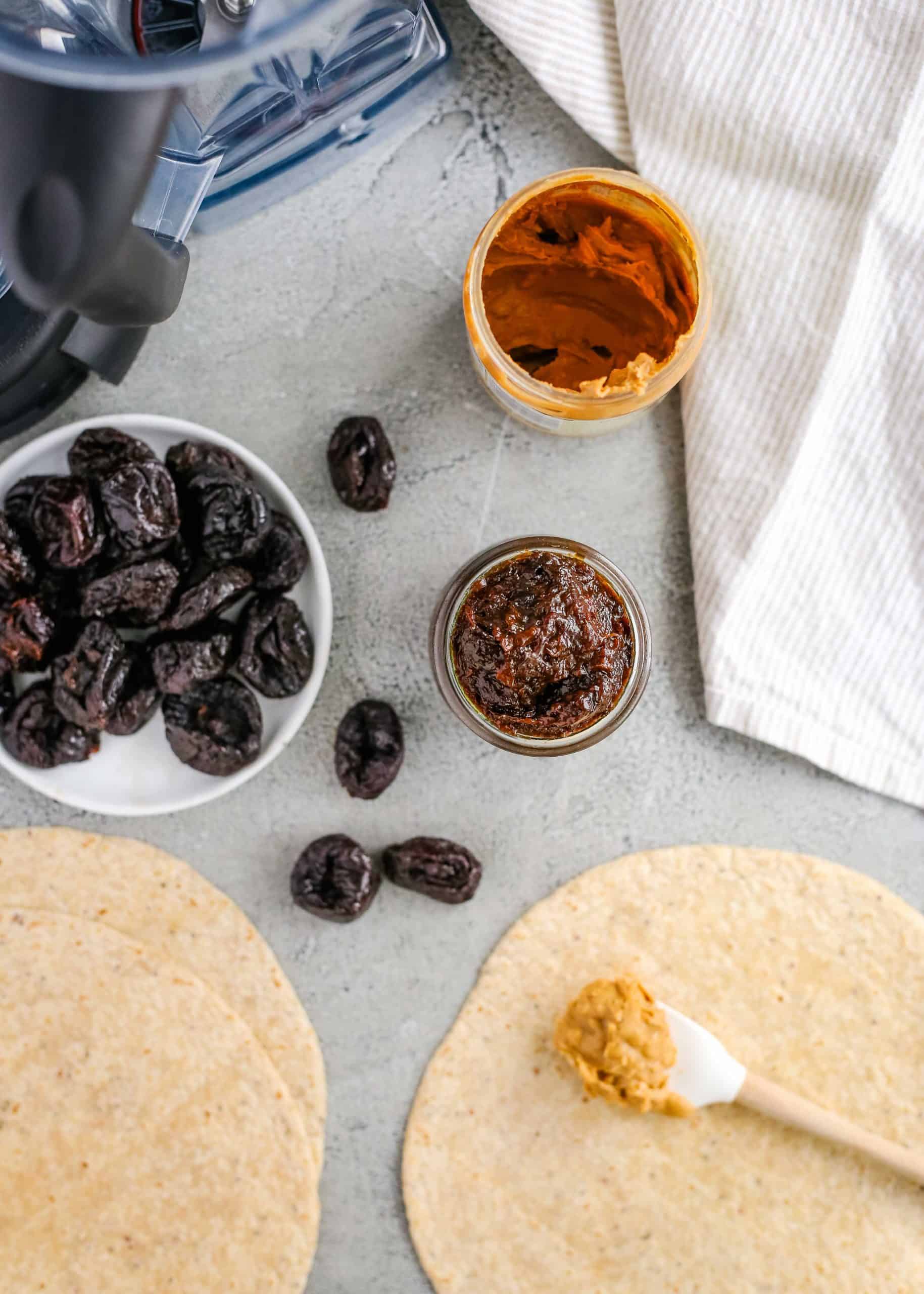 Overhead view of prunes with easy prune puree and peanut butter as an easy snack to enjoy the health benefits of prunes