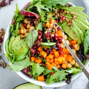 Colorful salad with pomegranate seeds and avocado