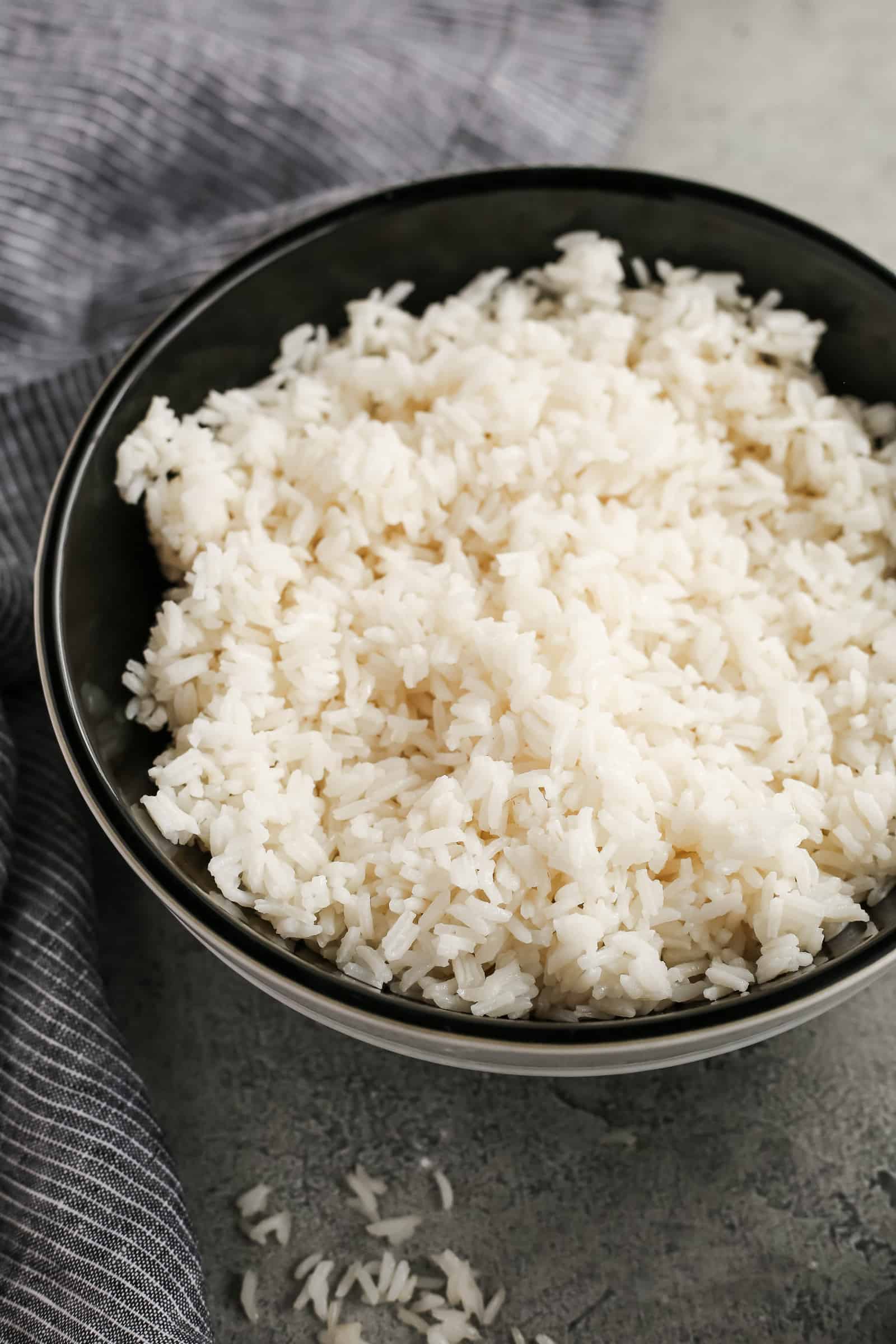 Mixing bowl of white rice, with the cooked grains looking fluffy and fresh