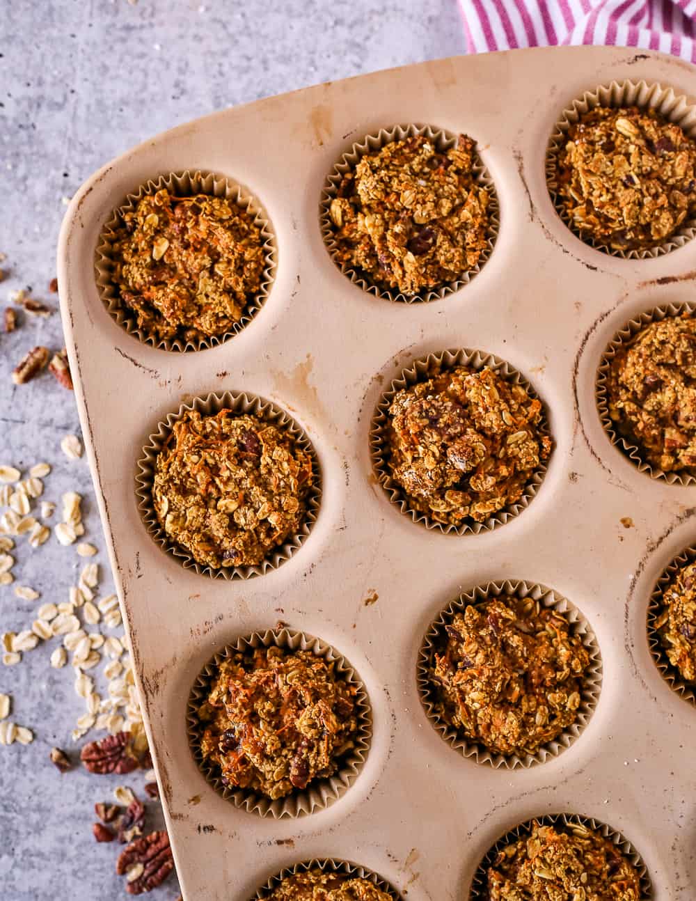 Overhead view of a muffin tin with healthy carrot cake muffins