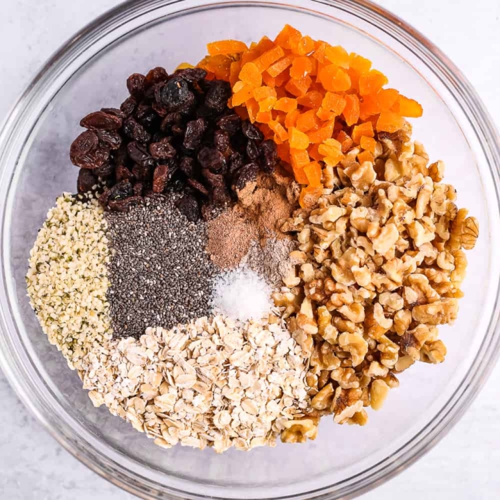Glass mixing bowl with unmixed muesli ingredients