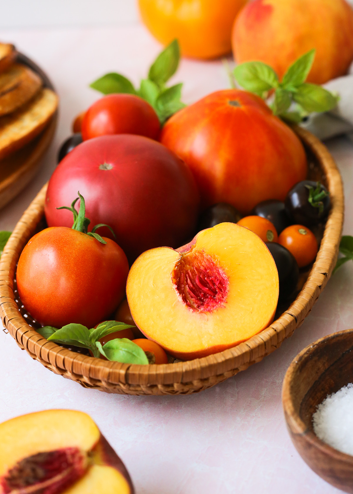 A ripe peach is sliced open to reveal and colorful flesh and smooth texture.