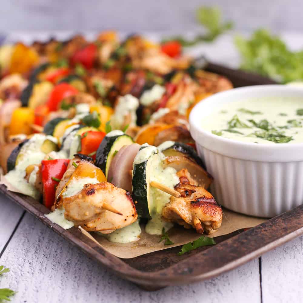 Yogurt marinated grilled chicken kebabs drizzled with a creamy cilantro feta sauce