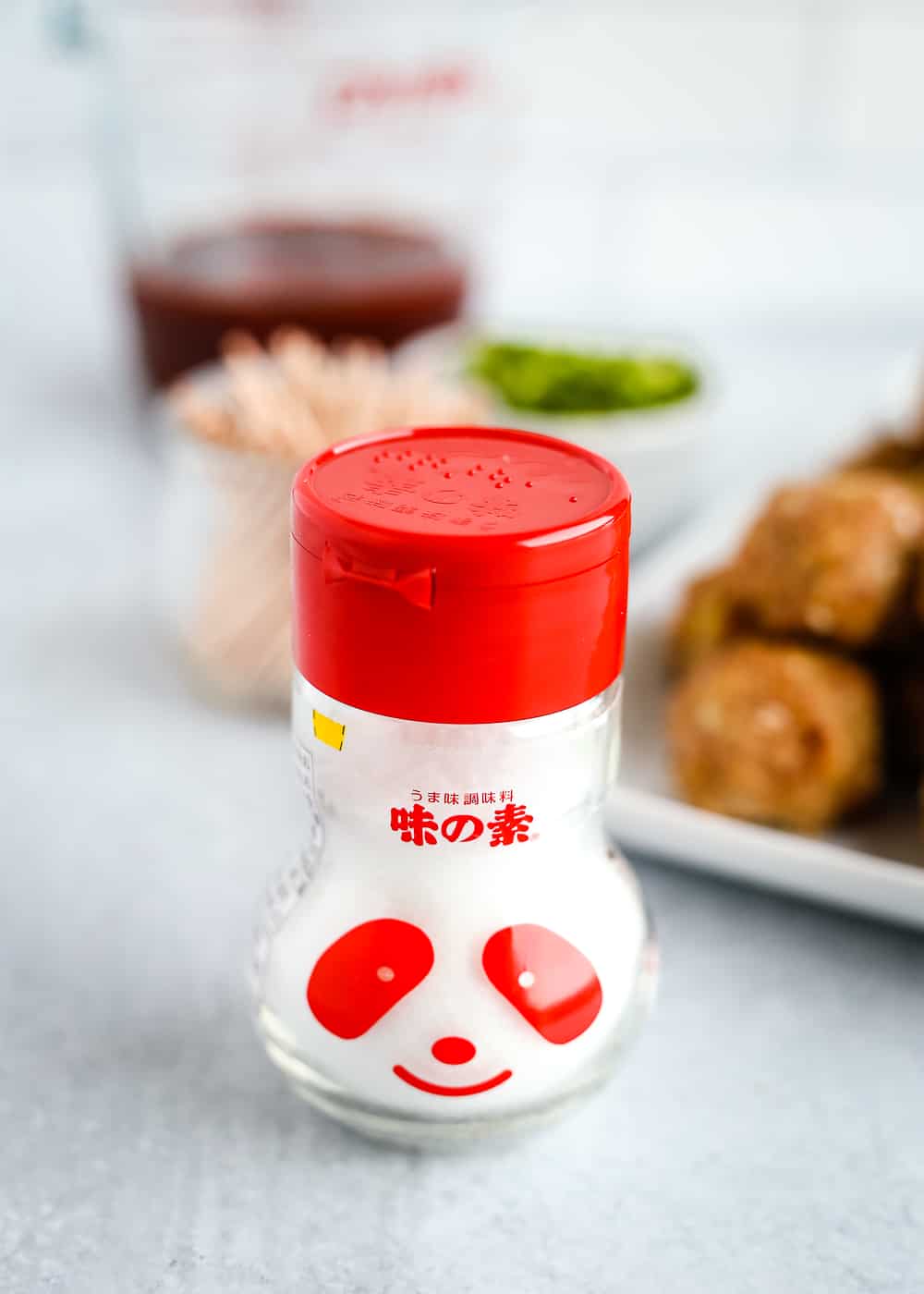 A shaker of MSG on a kitchen counter to be used in a spicy turkey meatball recipe