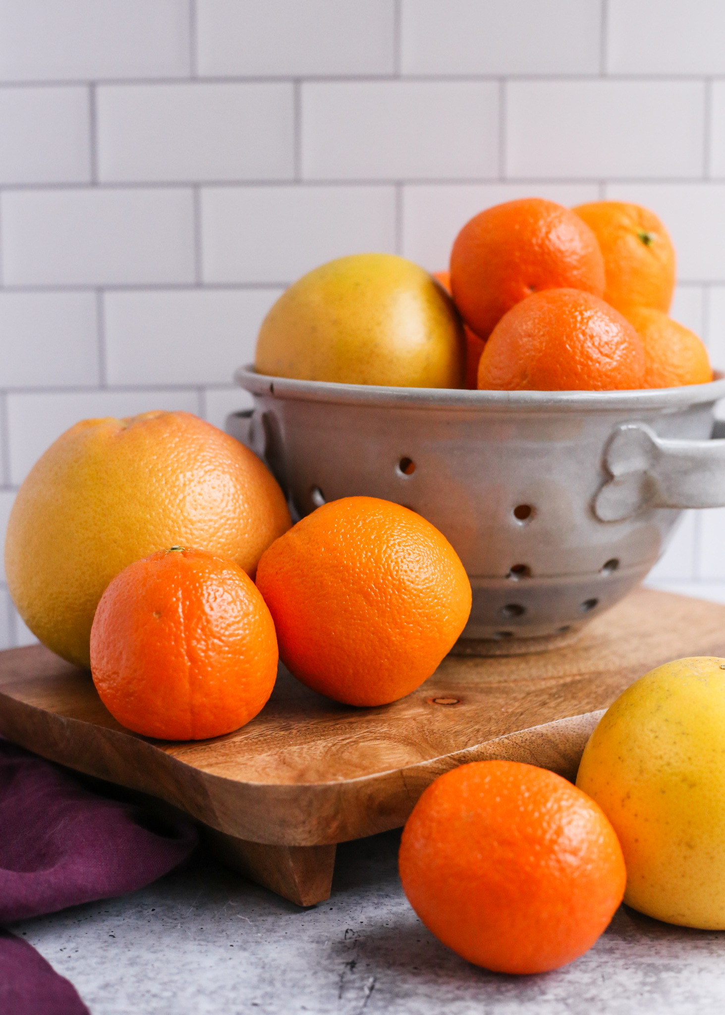 An assortment of Florida Citrus in a colander on a kitchen counter, including Florida Oranges, Florida Grapefruit, and Florida Tangerines