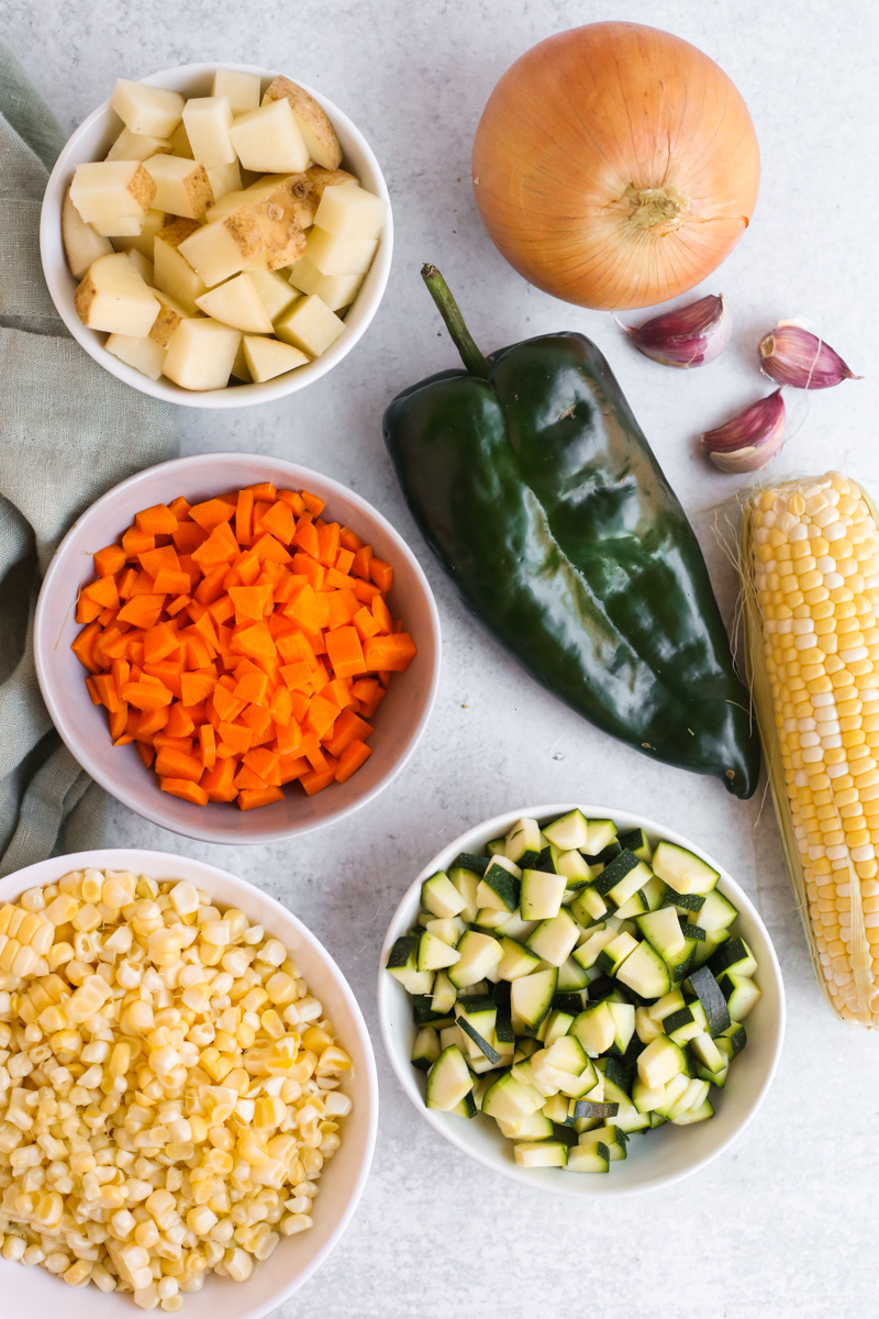 View of ingredients for a summer corn chowder recipe including potatoes and sweet corn that can be blended to help thicken corn chowder