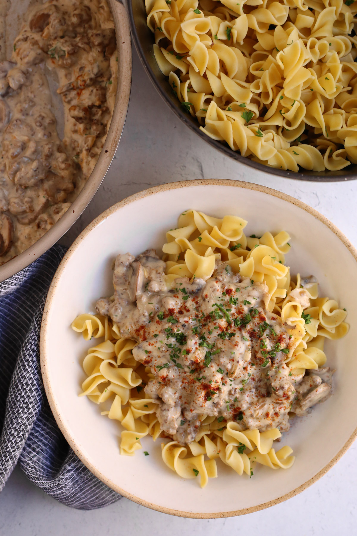 Overhead view of a ground beef stroganoff recipe served over egg noodles