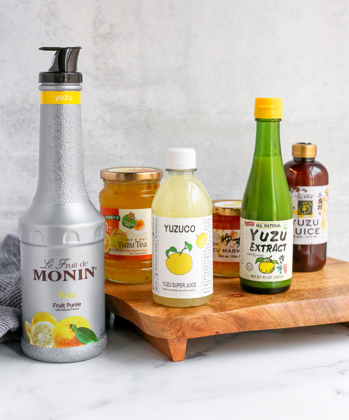 A display with a wide variety of options for how to use yuzu, including yuzu puree, yuzu juice, yuzu extract, and yuzu marmalade from various brands