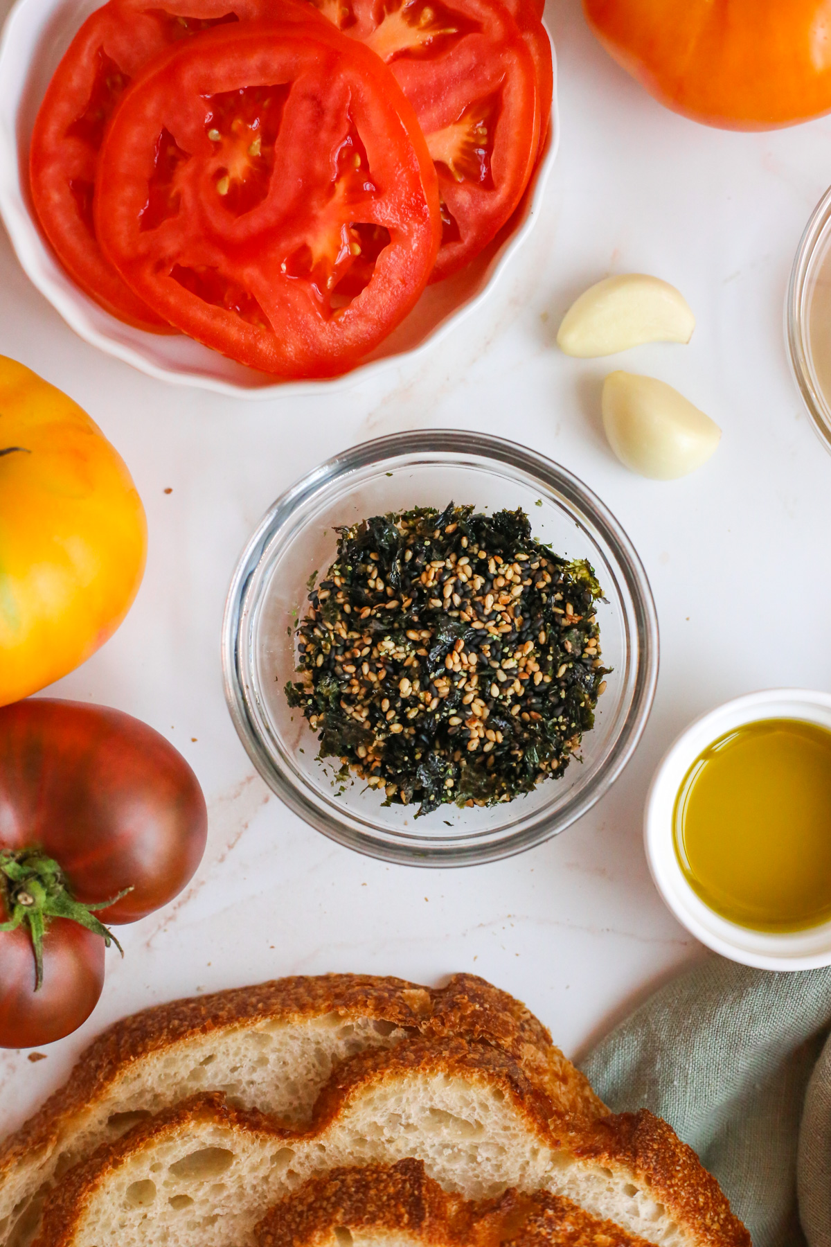 Close view of furikake in a small glass dish, showing the texture of the various ingredients including toasted sesame seeds and nori (dried seaweed)