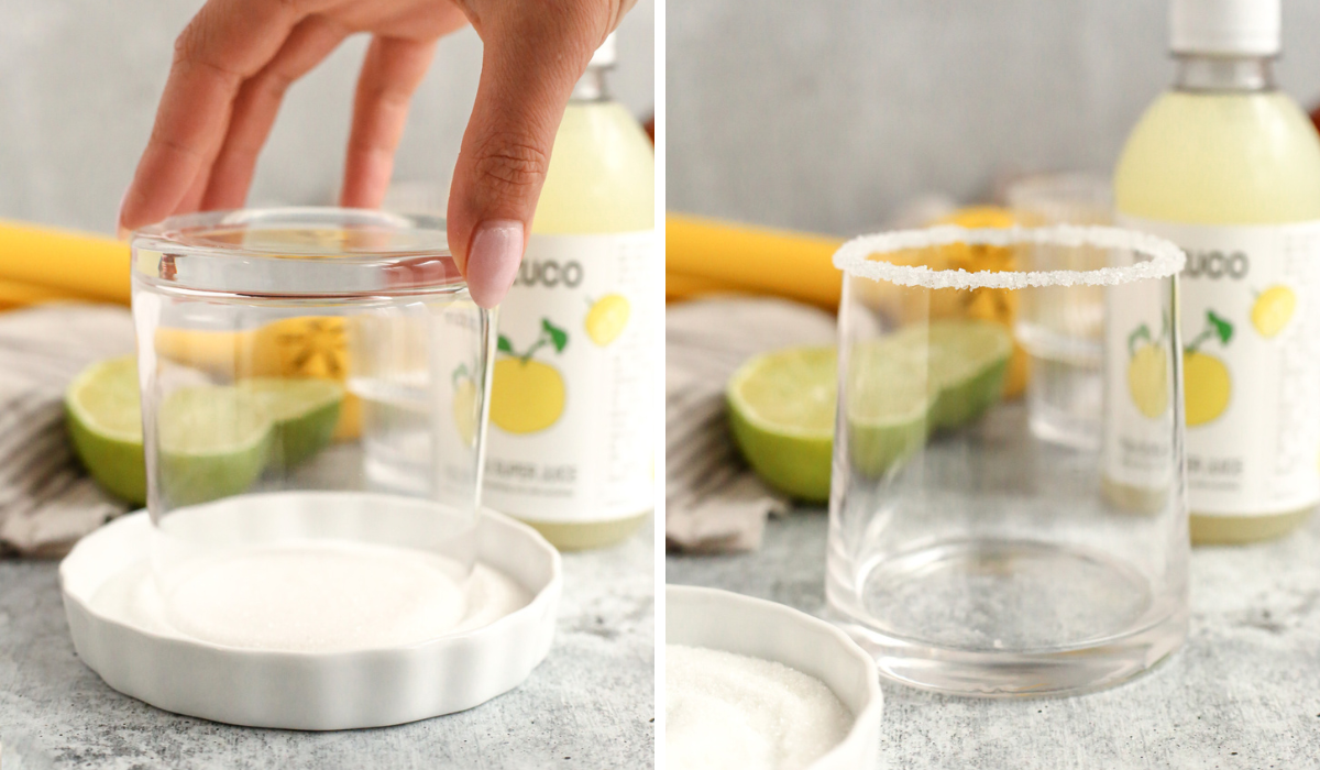 Side by side images showing the process to rim a cocktail glass with sugar. The left image shows a woman's hand dipping a clear glass, upside down, into a shallow white dish filled with sugar. The right image shows the same glass, right side up, with a sugar rim displayed in front of the ingredients needed to make a yuzu margarita