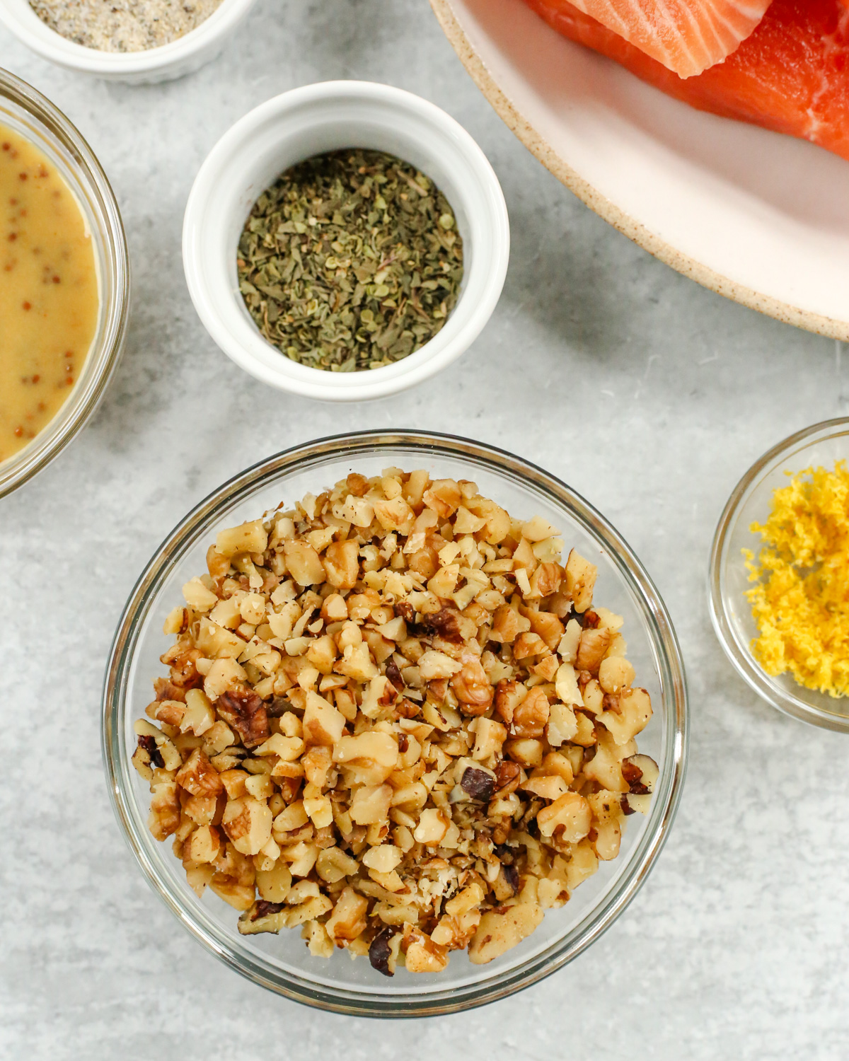 A closer view of chopped walnuts in a small glass ramekin, showing the ideal size for this recipe