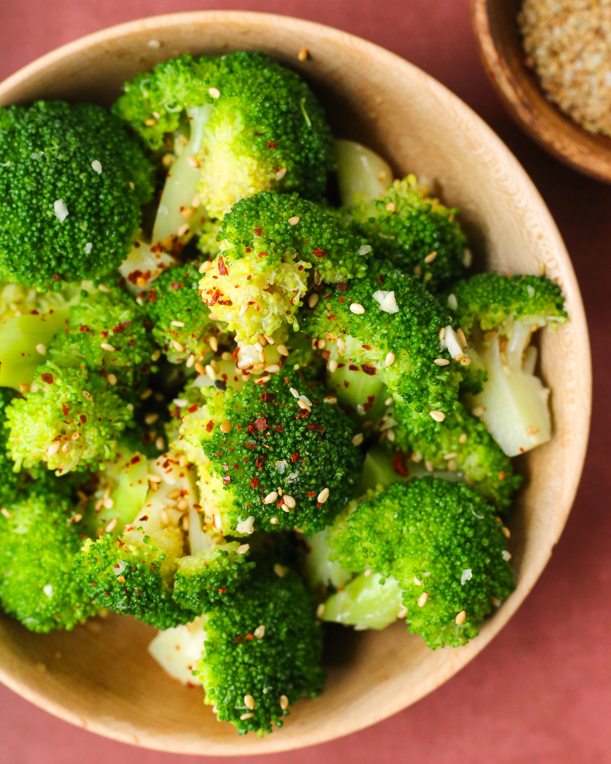 A serving of steamed Korean-style broccoli in a wooden bowl. 